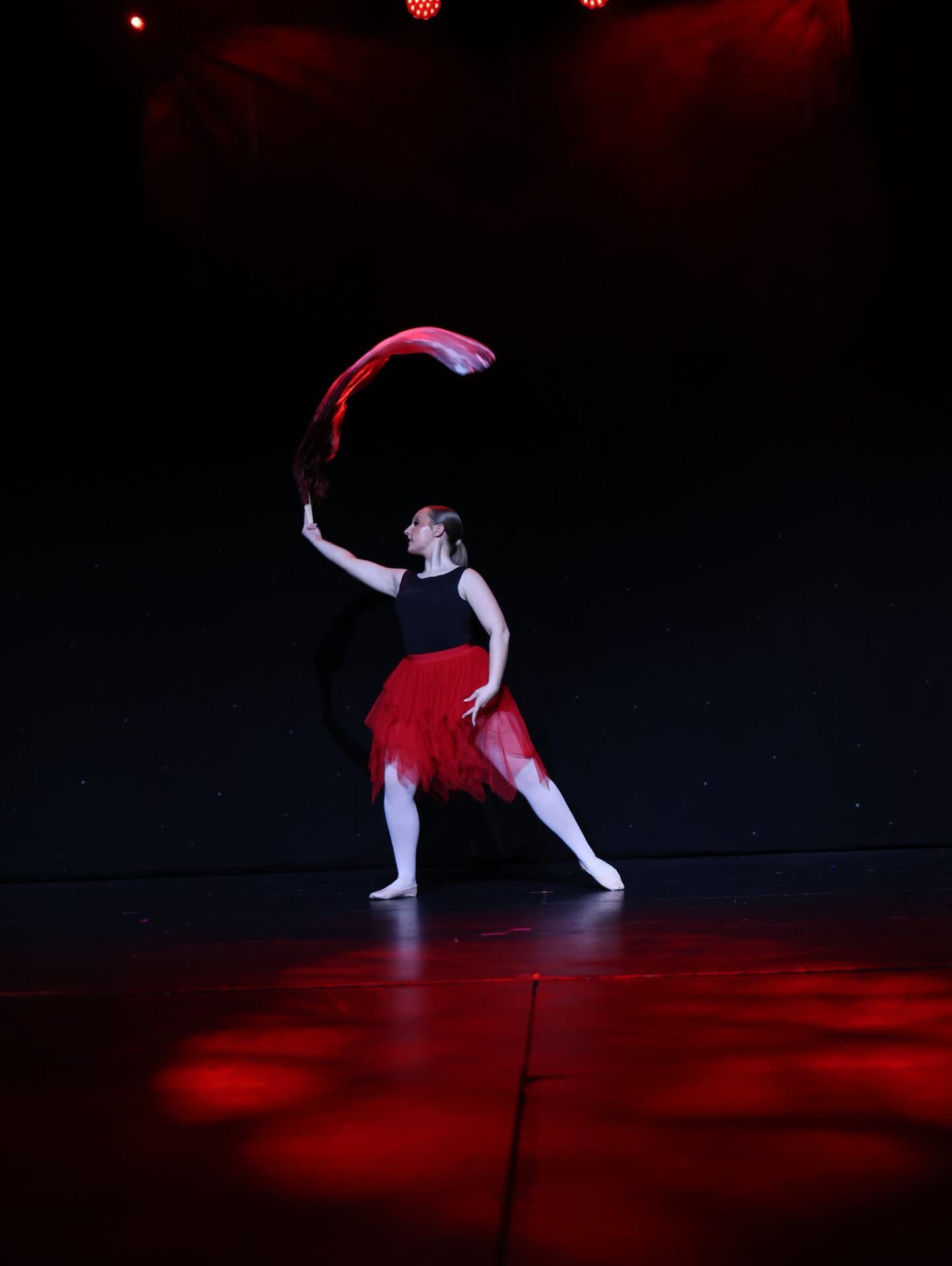Senior leap with red fan at the Princes Theatre