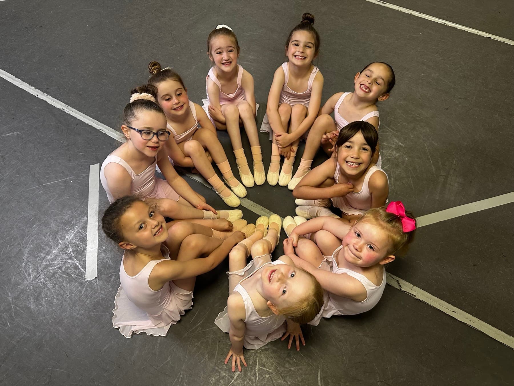 Tots ballet class sitting together in a circle in our Clacton studio